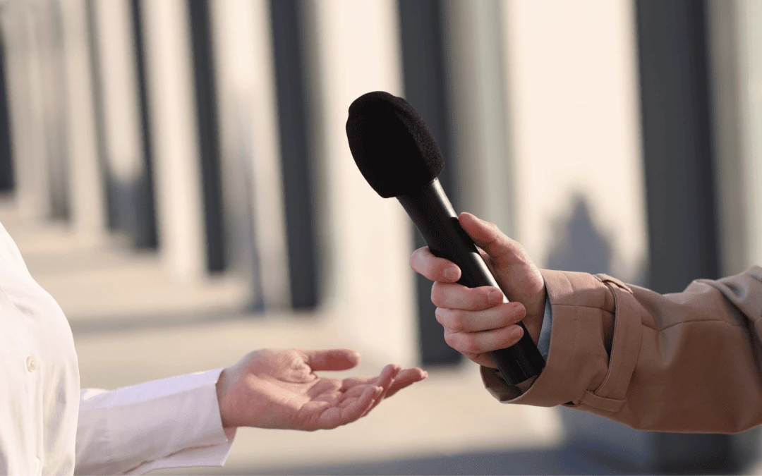 Professional giving a confident on-camera television interview to a news crew